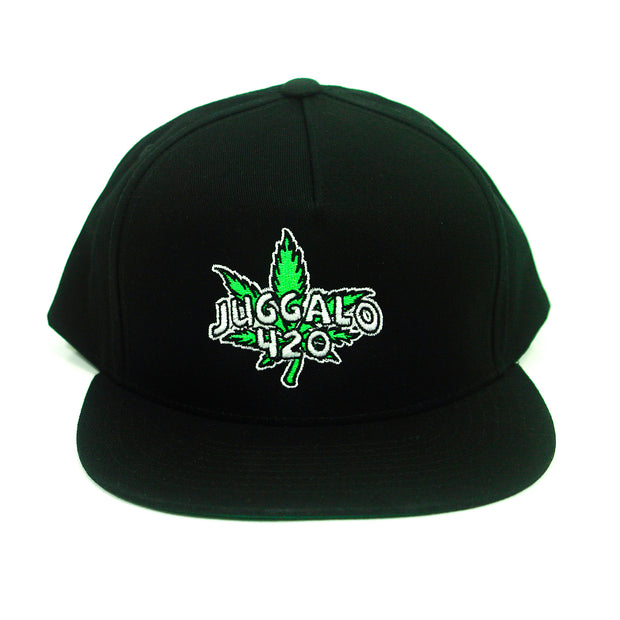 image of a black snapback hat on a white background. front embroidery of a green pot leaf with white text over that says juggalo 420