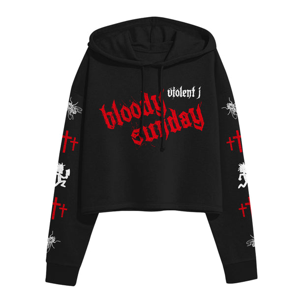 image of a black cropped ladies pullover hoodie on a white background. hoodie has center chest print that says bloody sunday and violent J. each sleeve has prints of flies, three crosses and a hatchetman logo