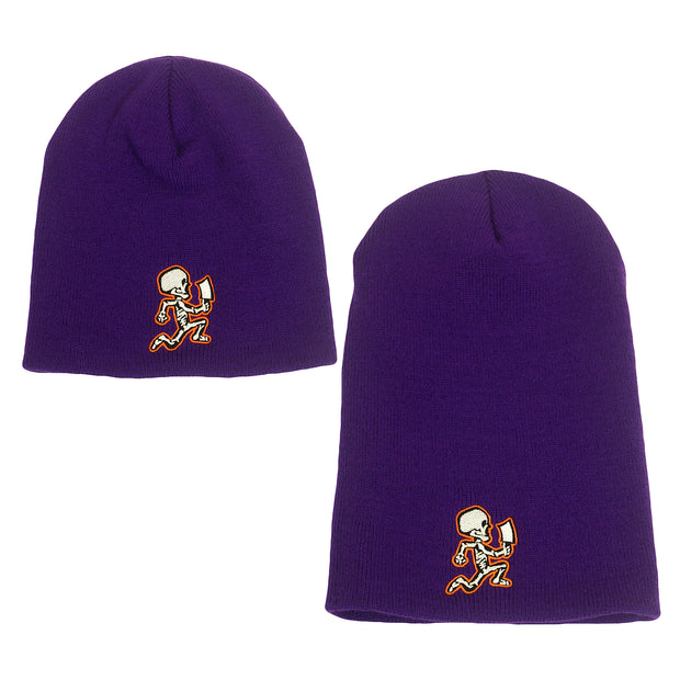 image of a small and a large purple winter beanie on a white background. small is on the left and large is on the right. both have white and orange embroidery across the bottom of a skeleton hatchetman