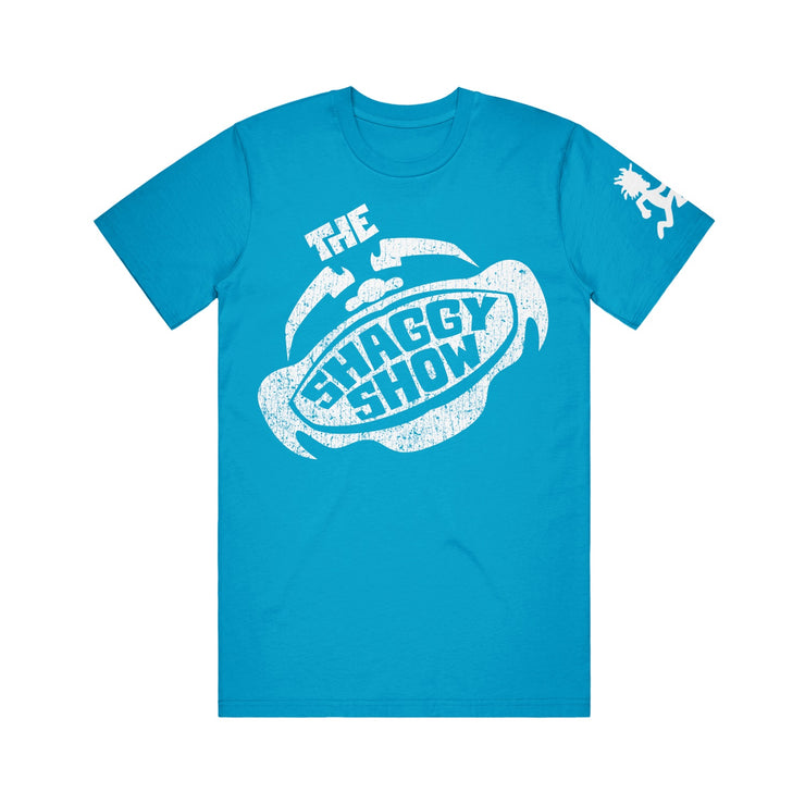 image of a blue tee shirt on a white background. tee has center print in white that says the shaggy show. white logo of the hatchetman on right sleeve