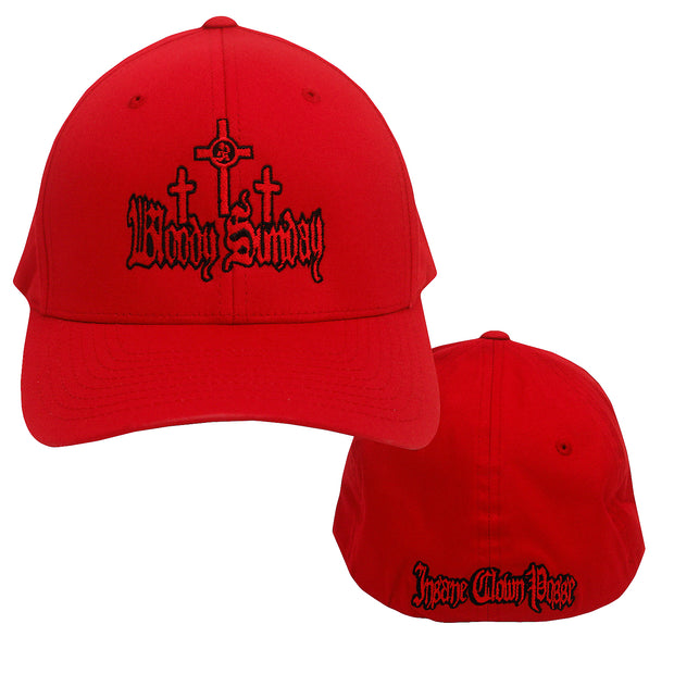 image of the front and back of a red flexfit hat on a white background. front is on the left and has red and black embroidery of three crosses above the words Bloody Sunday. the back is on the right and has red and black embroidery along the center bottom that says Insane Clown Posse